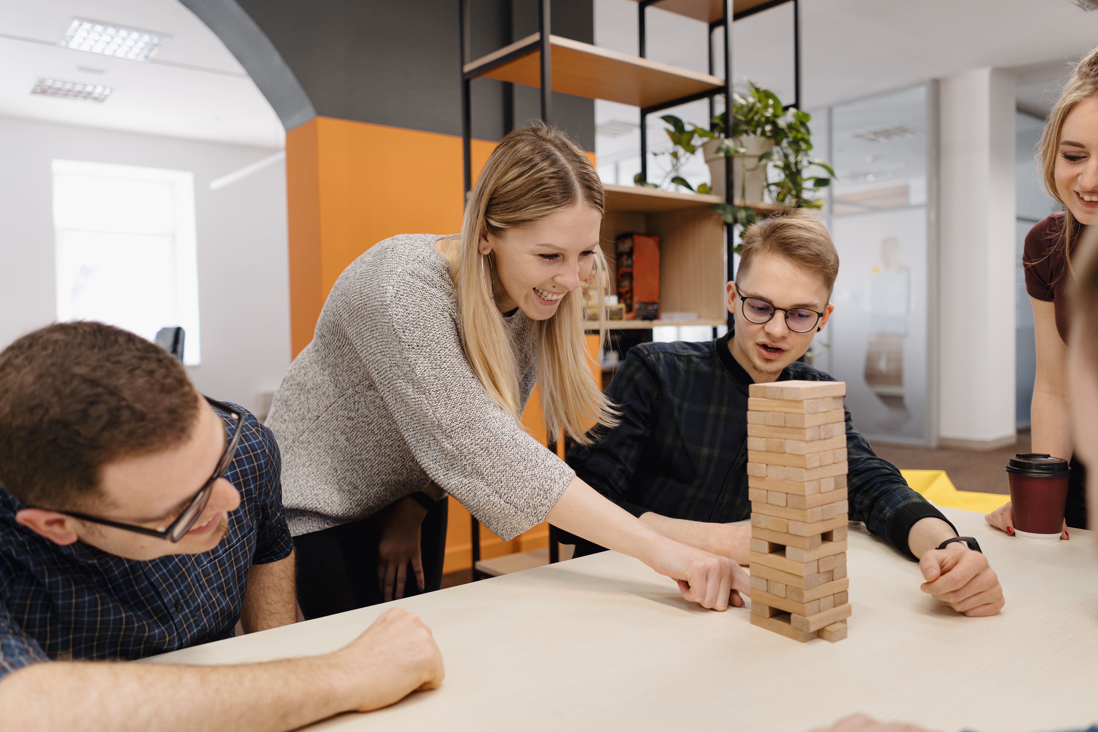 mixed-team-playing-blocks-wood-game-office